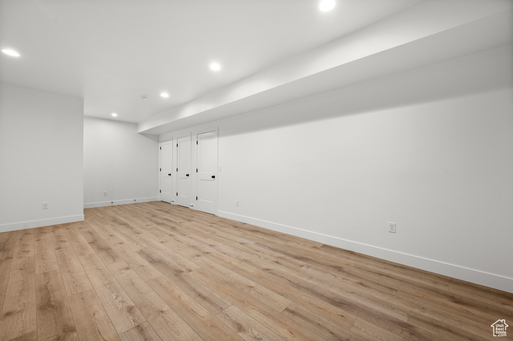 Unfurnished room with recessed lighting, light wood-style flooring, and baseboards