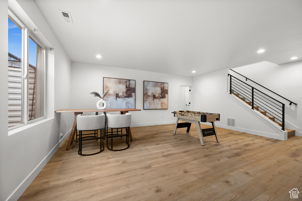Playroom featuring wood finished floors, baseboards, and recessed lighting