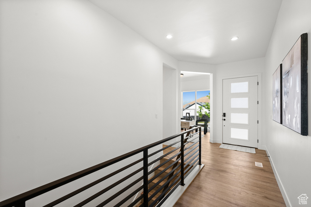 Entryway with baseboards, recessed lighting, and light wood-type flooring