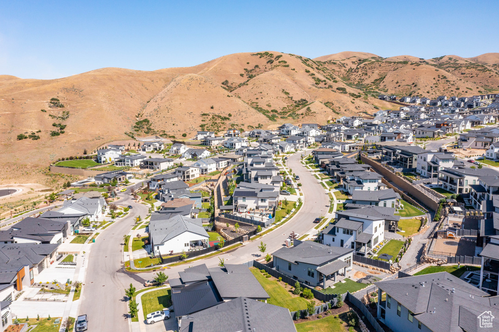 Aerial view of property\'s location with nearby suburban area and a mountainous background