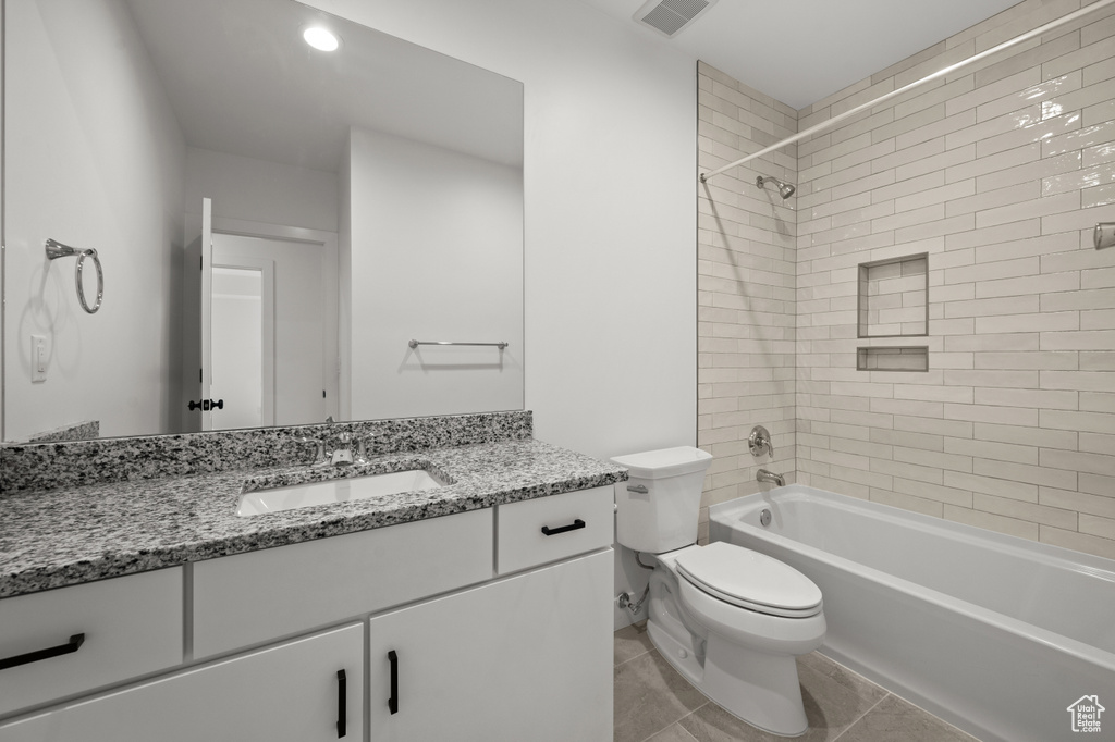 Bathroom with toilet, vanity, shower / bath combination, and tile patterned floors