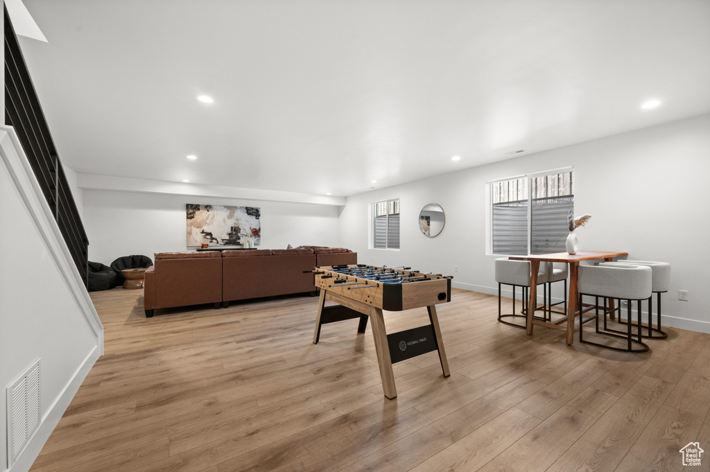 Recreation room featuring recessed lighting, light wood-style floors, and baseboards