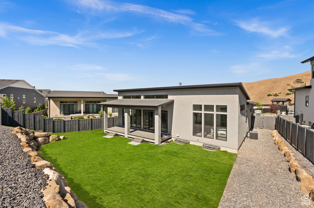 Back of house with stucco siding and a mountain view