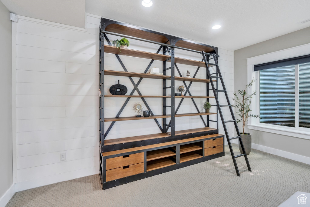 Detailed view of carpet, baseboards, and recessed lighting