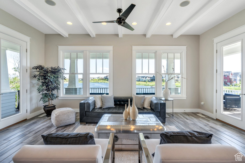 Living area with hardwood / wood-style flooring, beam ceiling, baseboards, a ceiling fan, and recessed lighting