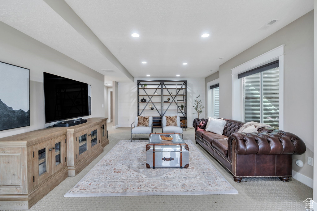 Living area featuring carpet flooring, recessed lighting, and baseboards
