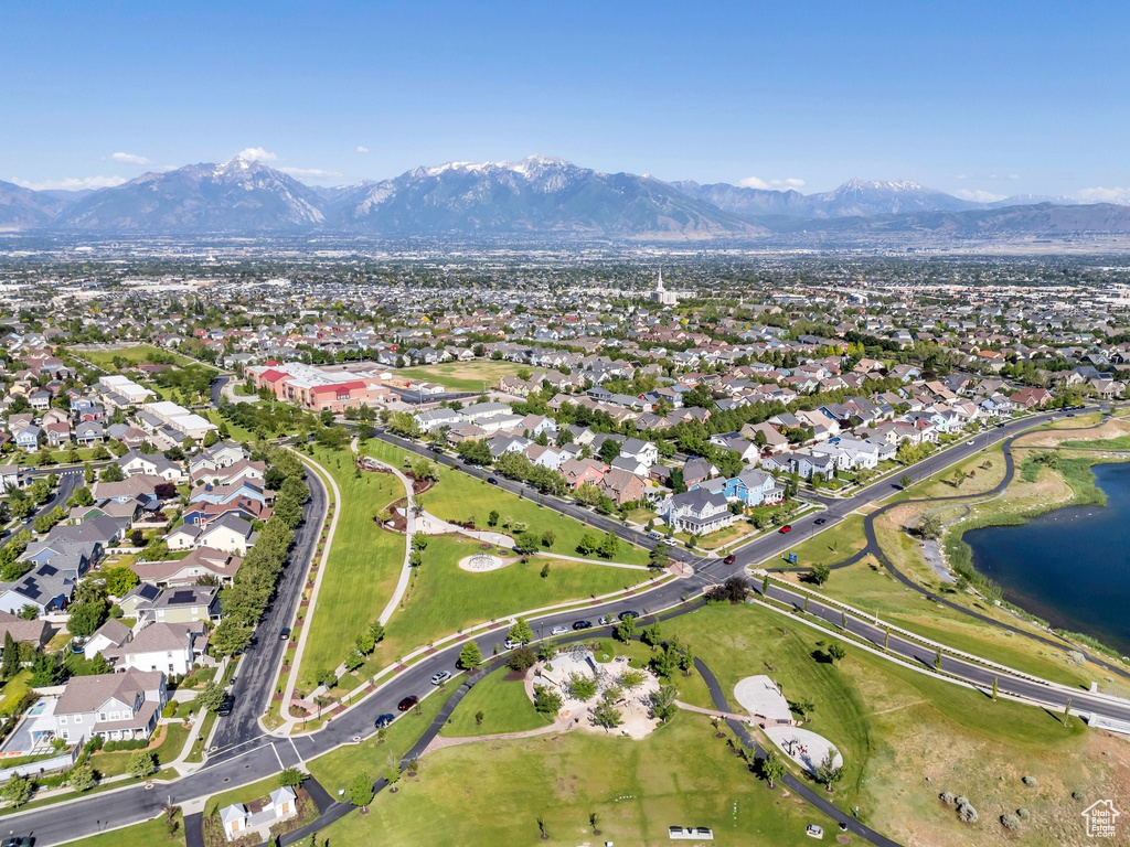 Aerial overview of property's location featuring a water and mountain view and nearby suburban area