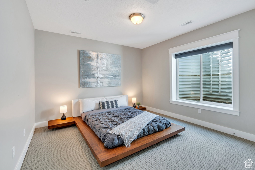 Carpeted bedroom featuring baseboards