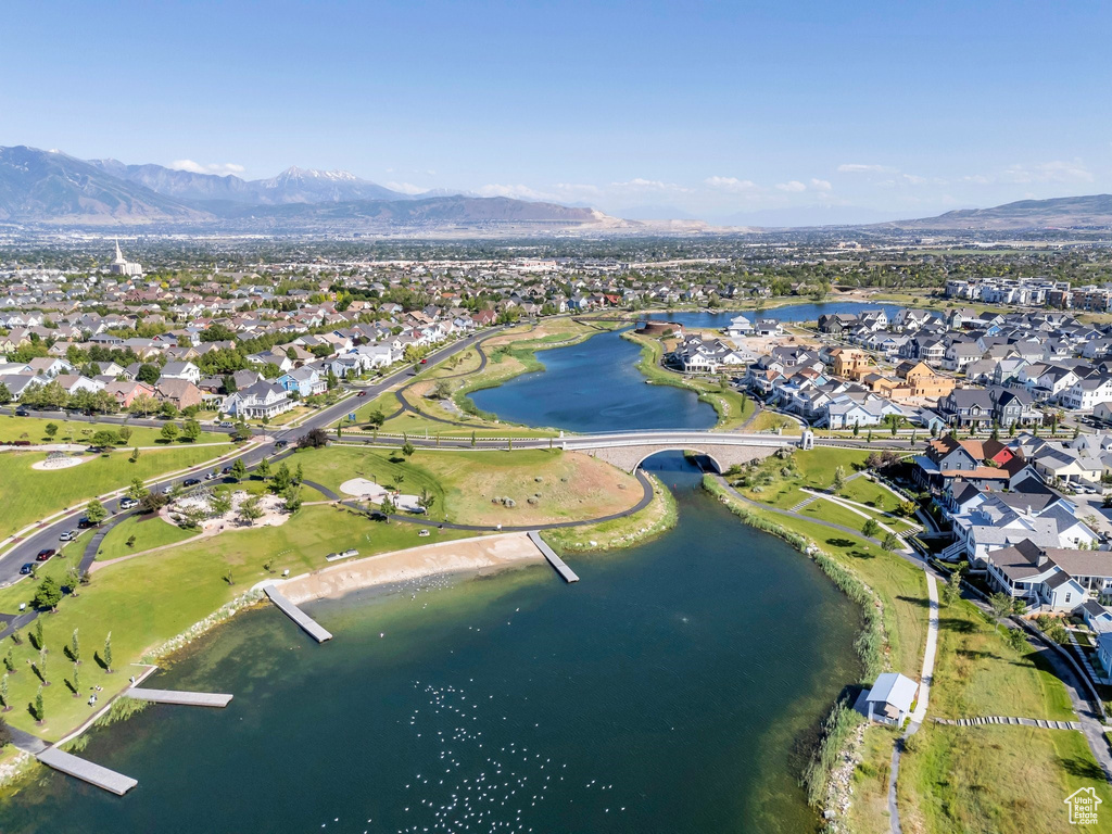 Aerial view of property's location featuring a water and mountain view and nearby suburban area