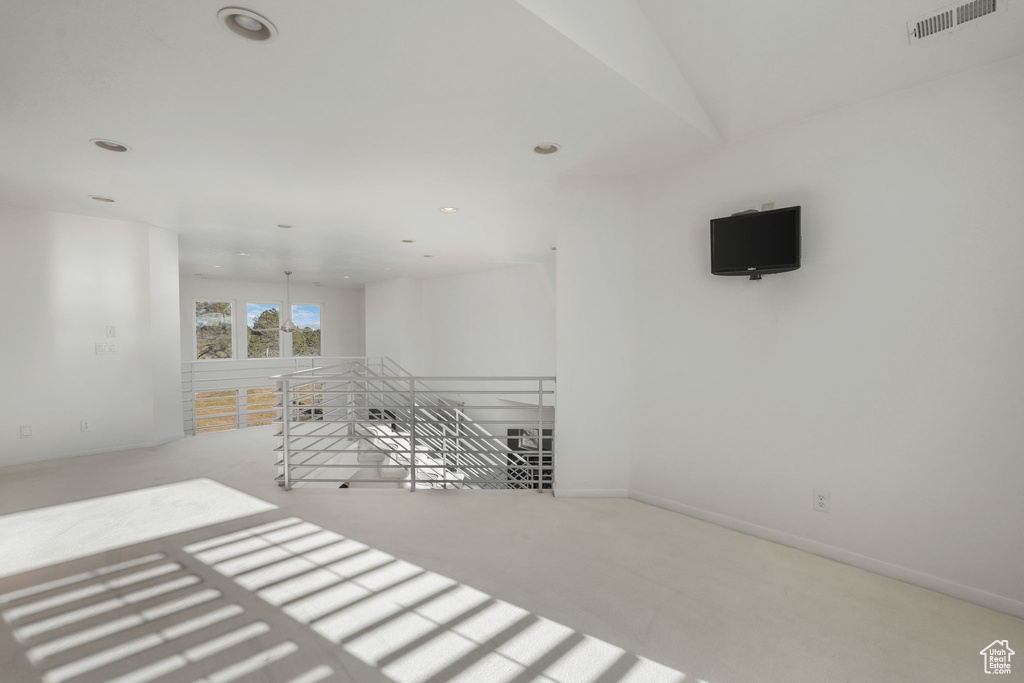 Spare room featuring carpet floors, recessed lighting, and baseboards
