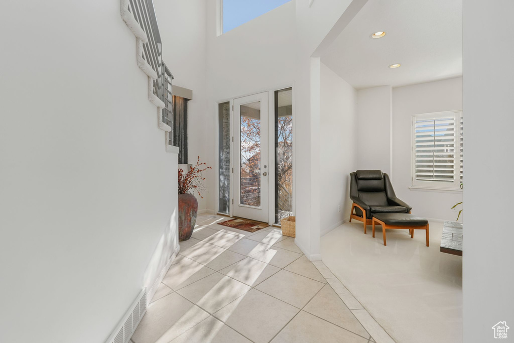 Entryway with plenty of natural light, tile patterned floors, recessed lighting, and baseboards