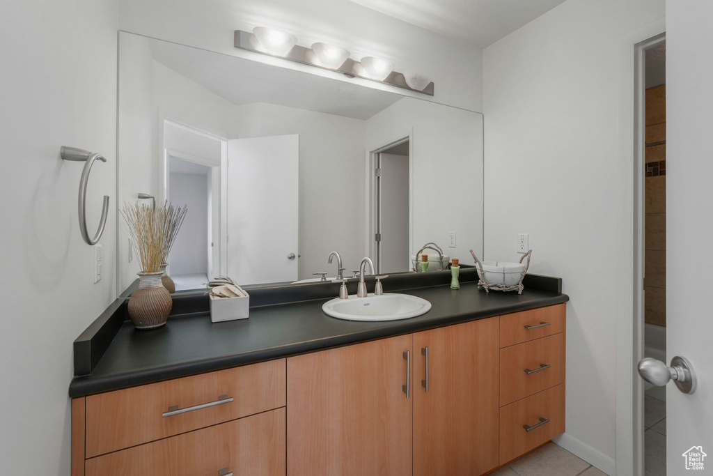 Bathroom featuring vanity and tile patterned flooring