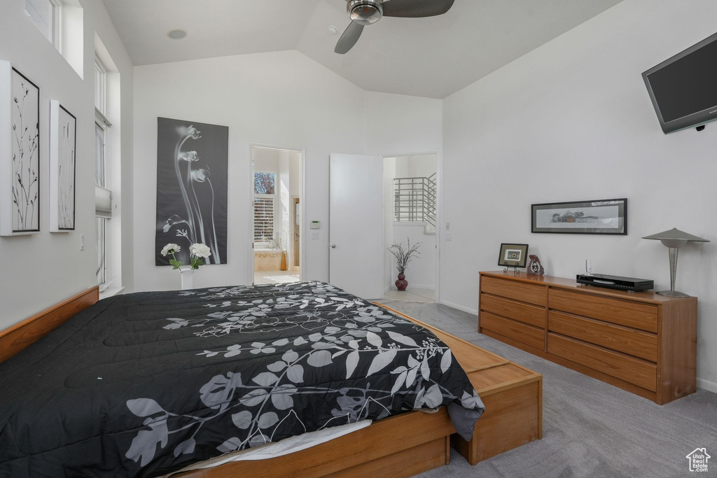 Carpeted bedroom featuring lofted ceiling, baseboards, a ceiling fan, and ensuite bathroom