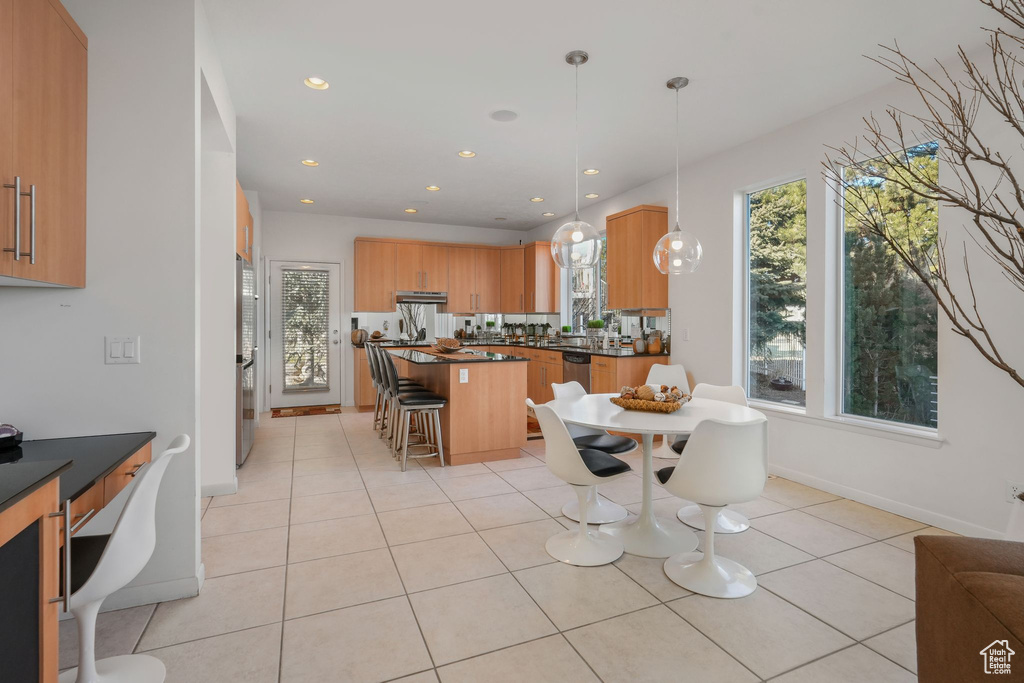 Dining area with light tile patterned floors, recessed lighting, and baseboards