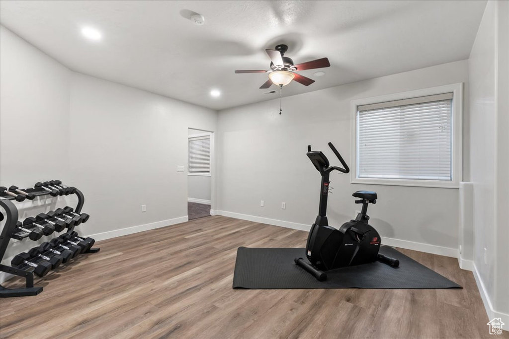 Workout area featuring ceiling fan, wood finished floors, baseboards, and recessed lighting