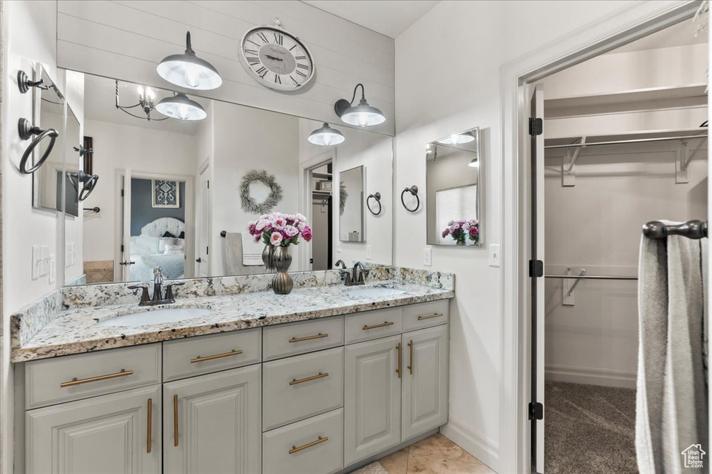 Ensuite bathroom with double vanity and a walk in closet