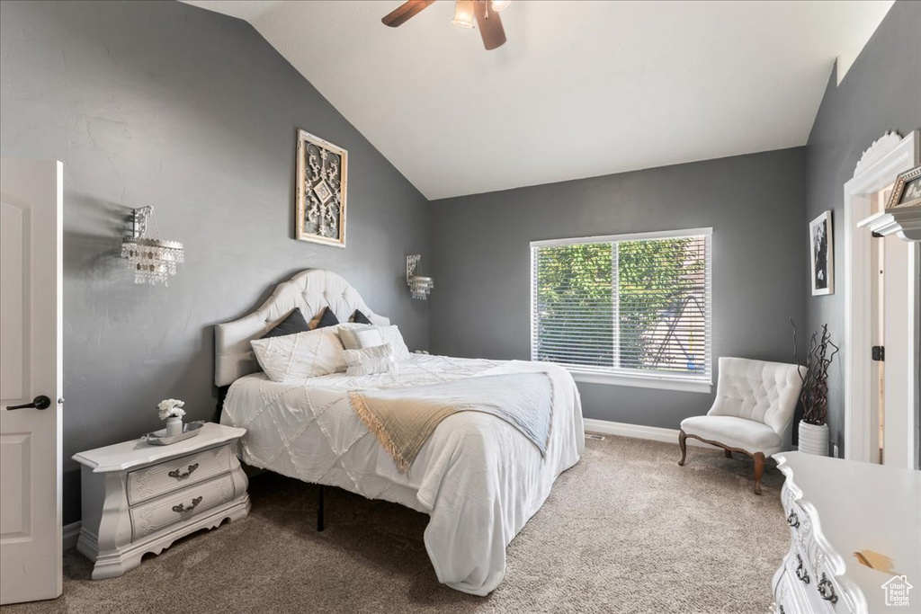 Bedroom featuring carpet floors, lofted ceiling, baseboards, and ceiling fan