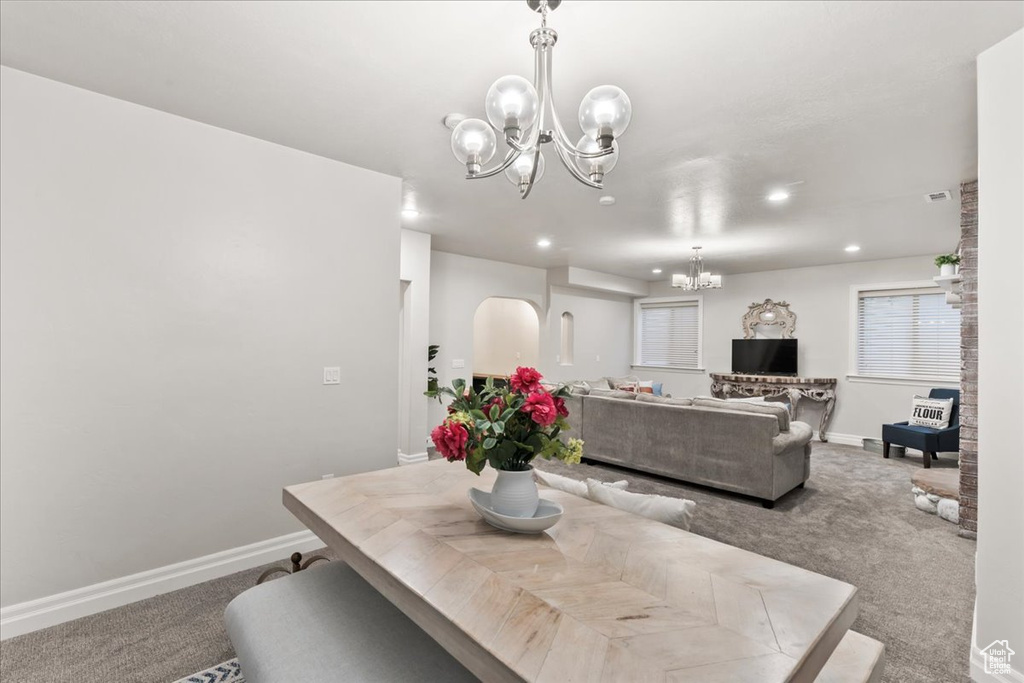 Carpeted dining space featuring a chandelier, recessed lighting, and baseboards