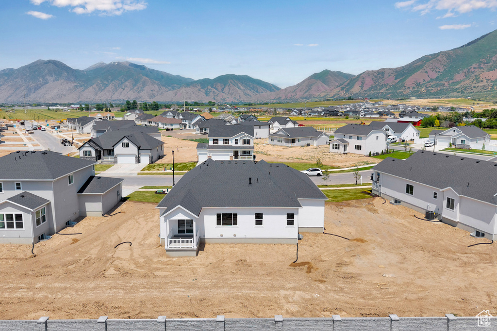 Aerial perspective of suburban area featuring a mountain backdrop