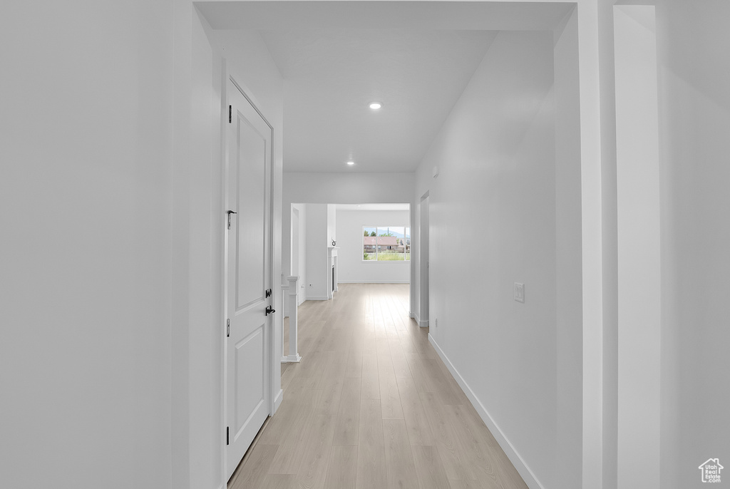 Corridor featuring recessed lighting, light wood finished floors, and baseboards