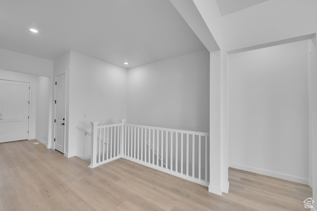 Hall featuring an upstairs landing, light wood-type flooring, recessed lighting, and baseboards