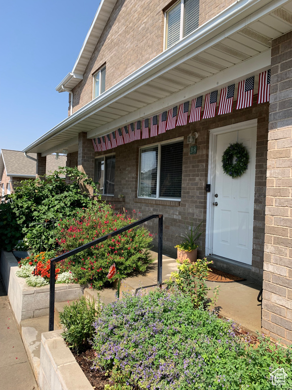 View of exterior entry with brick siding