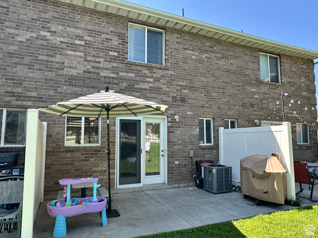 Rear view of house featuring a patio and cooling unit