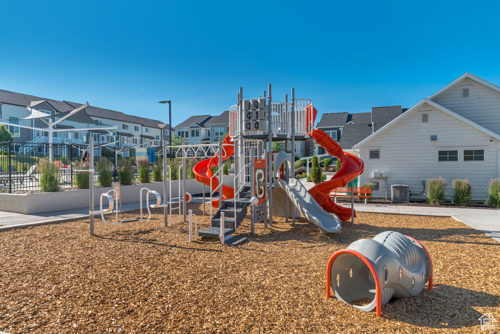 Community playground featuring a residential view and central AC unit