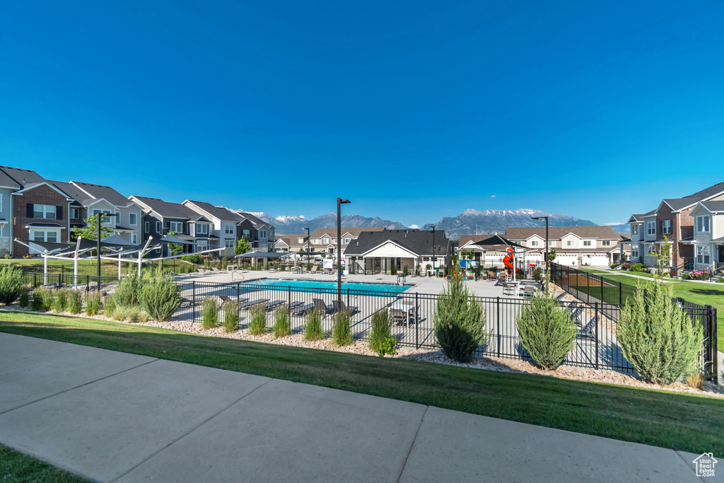 Community pool with a residential view and a mountain view