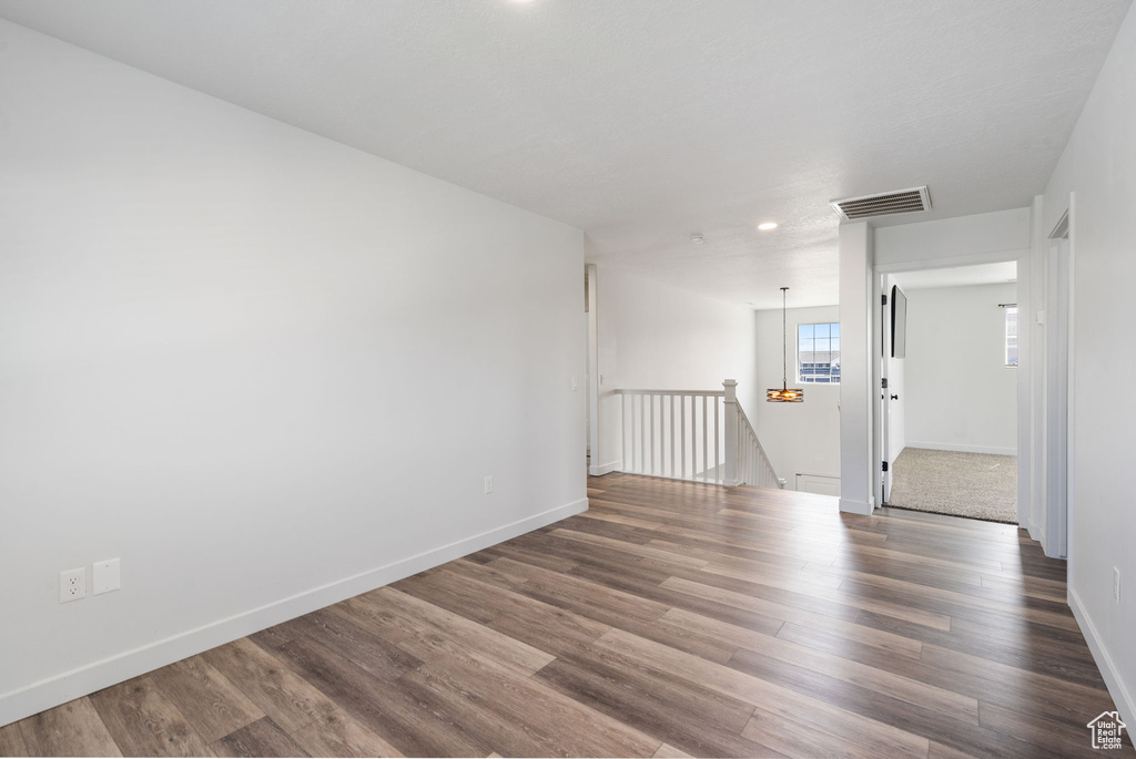 Empty room with wood finished floors, baseboards, and recessed lighting