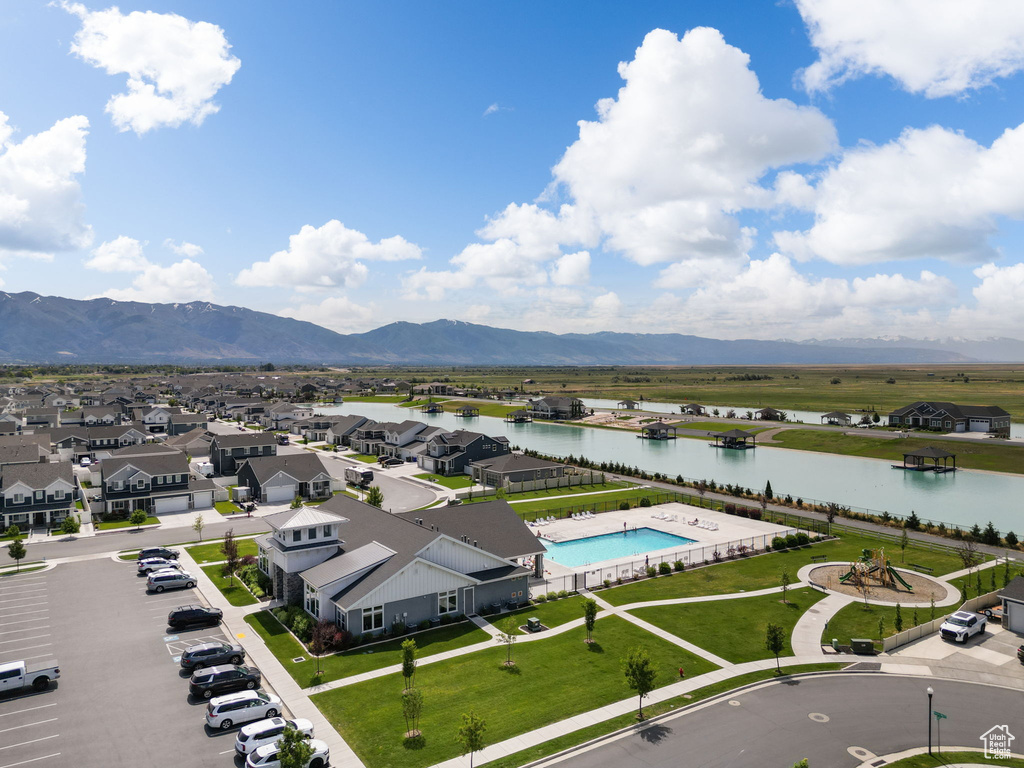 Aerial view of residential area with a water and mountain view and a pool