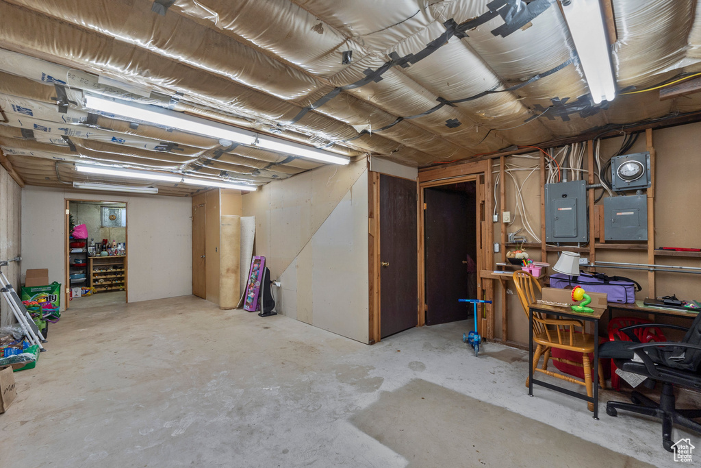 Unfinished basement with electric panel
