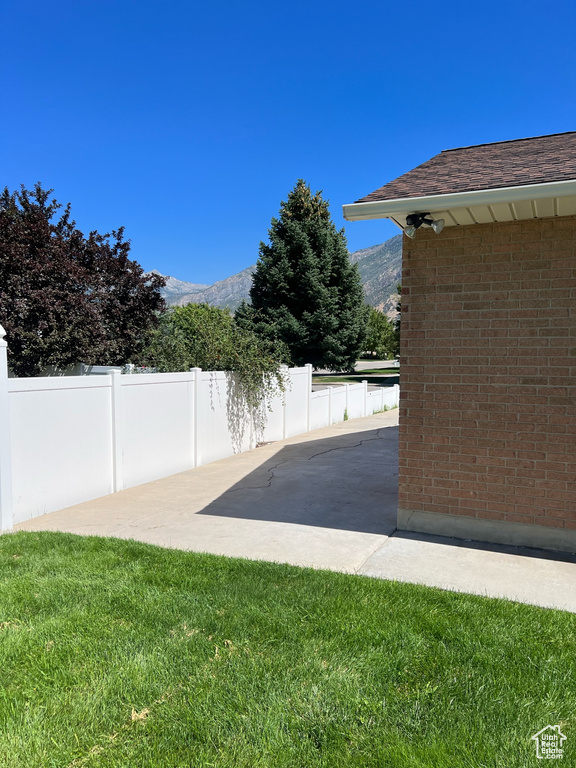 View of yard with a patio and a mountain view
