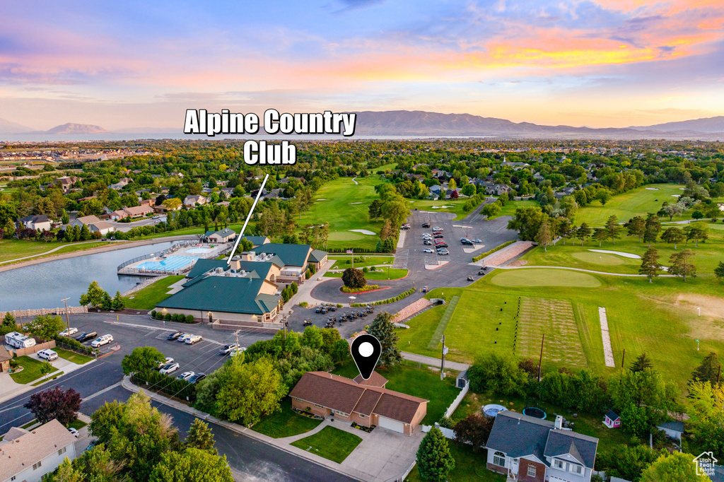 Aerial view at dusk of a water and mountain view and view of golf course