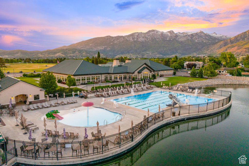 Community pool with a patio and a mountain view