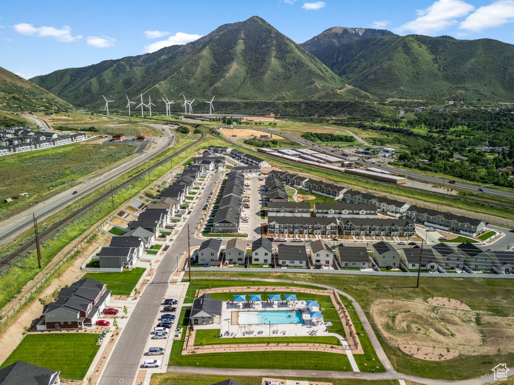 Aerial view of property and surrounding area with a pool area and mountains