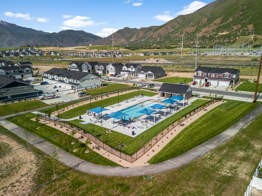 Aerial view of residential area featuring mountains and a pool