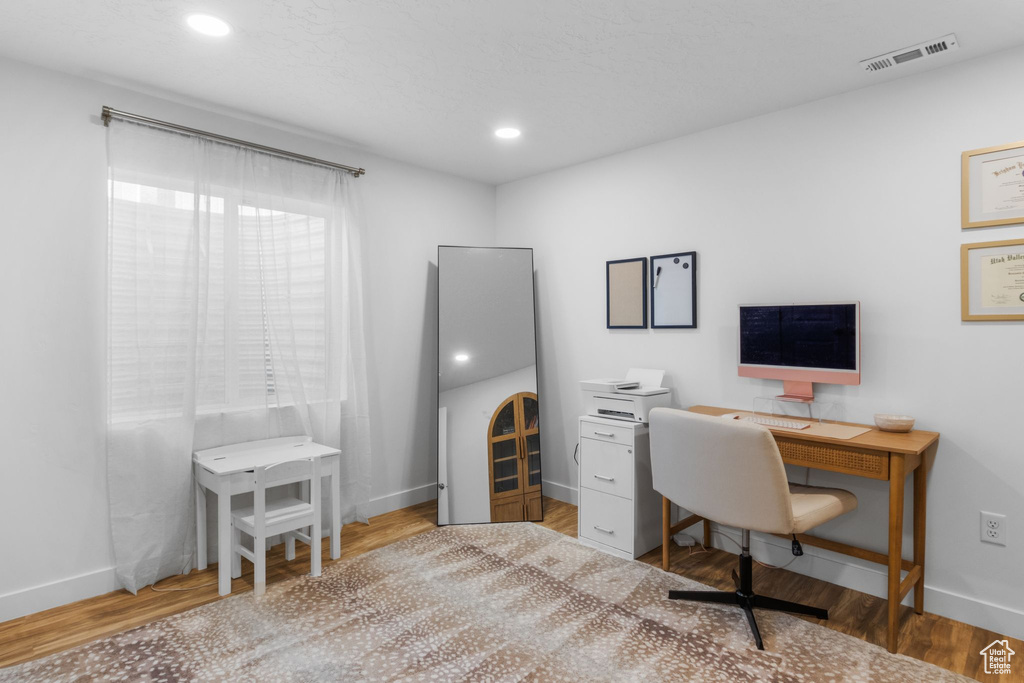 Office area featuring baseboards, wood finished floors, and recessed lighting