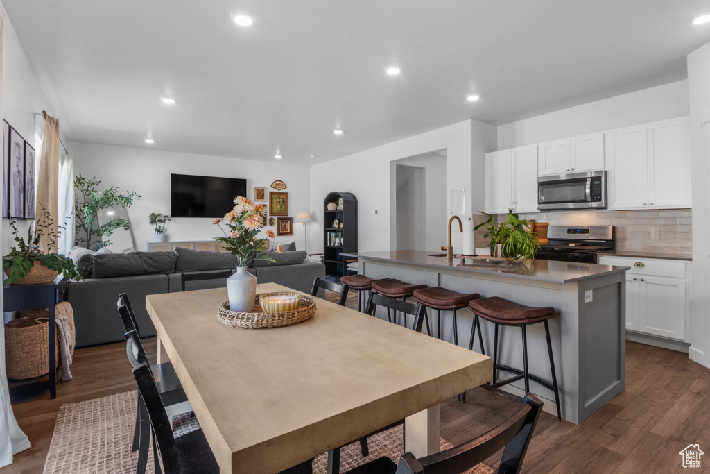 Dining area featuring recessed lighting and dark wood-style floors