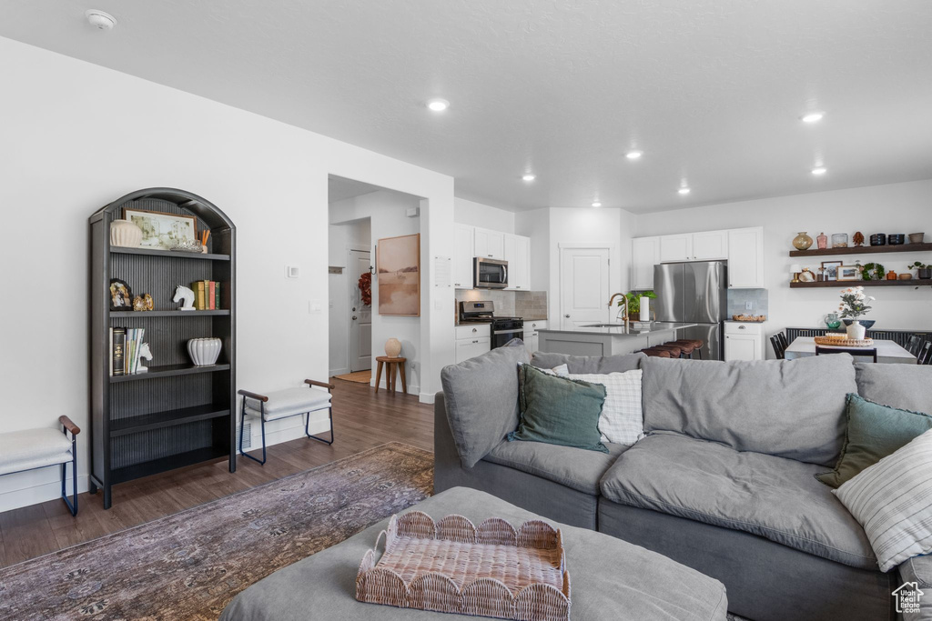 Living area with dark wood-style floors and recessed lighting