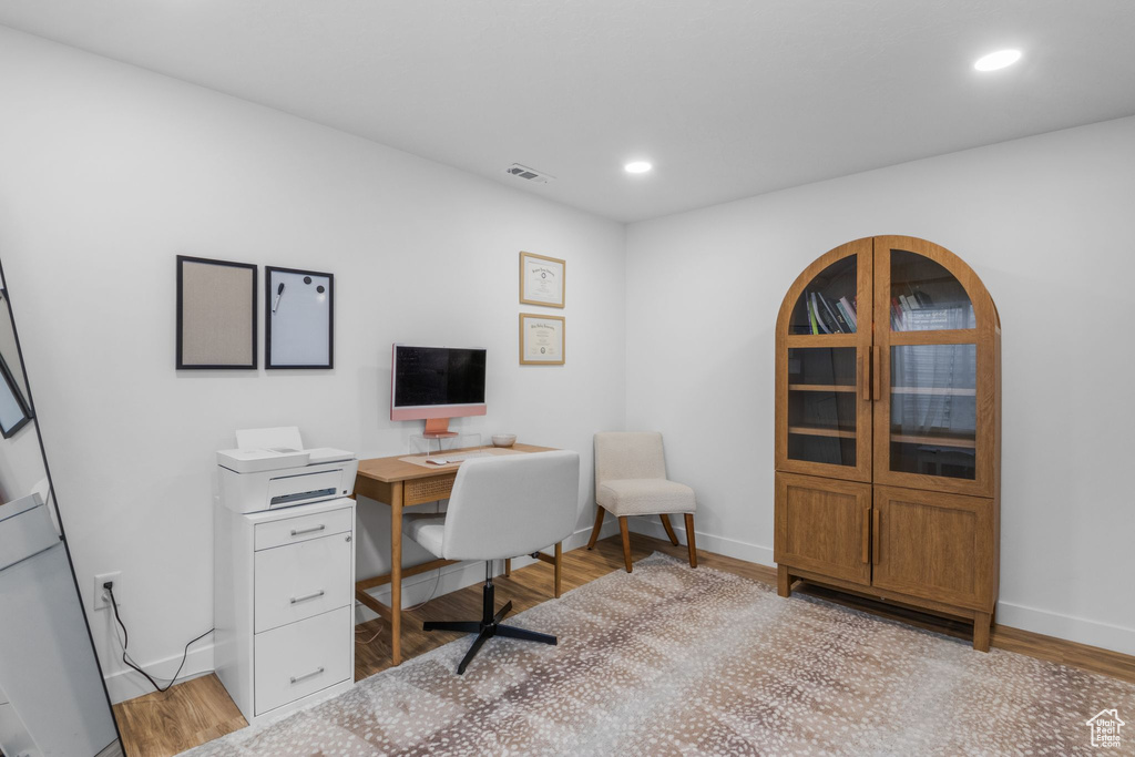 Office area featuring baseboards, light wood finished floors, and recessed lighting