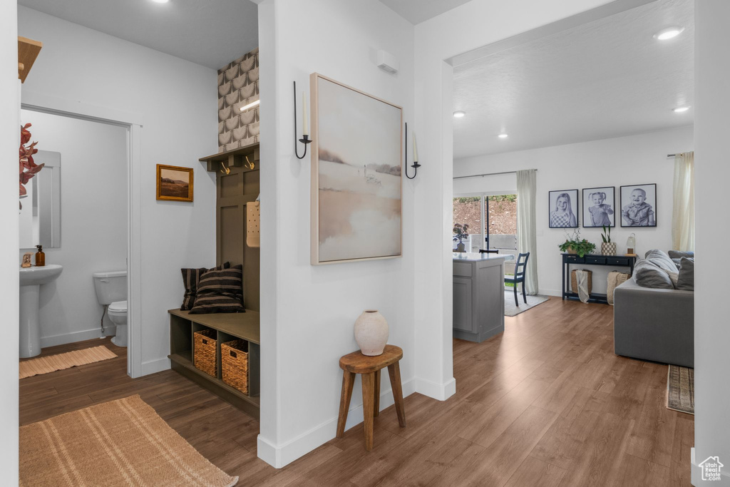 Hallway with wood finished floors, recessed lighting, and baseboards