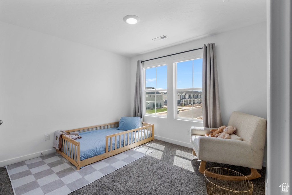 Carpeted bedroom featuring baseboards