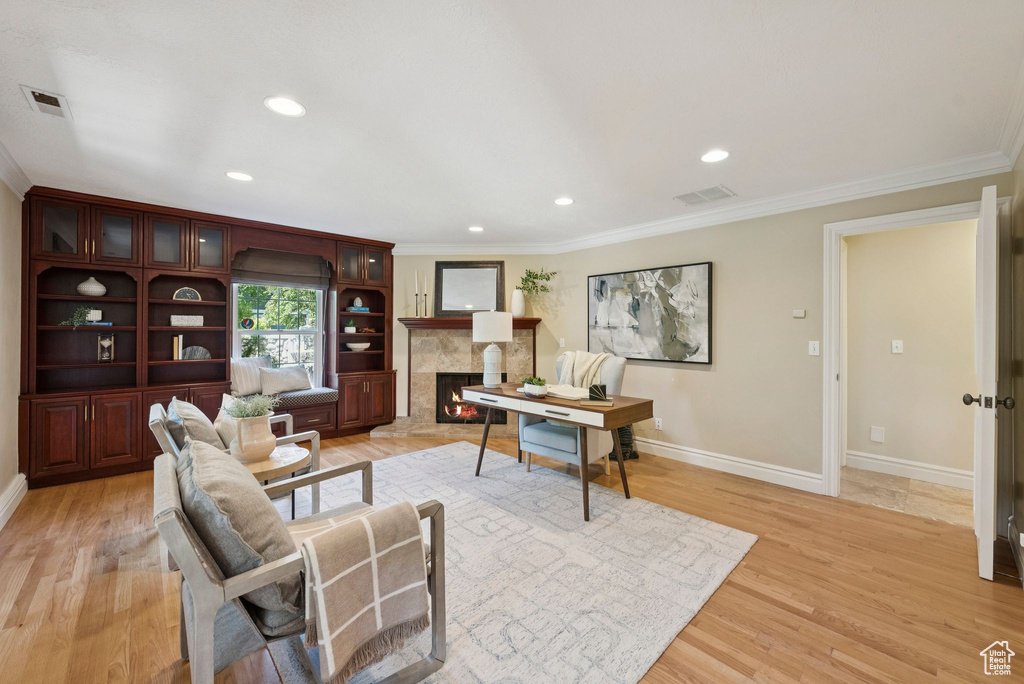 Office with ornamental molding, baseboards, light wood-style flooring, a fireplace, and recessed lighting