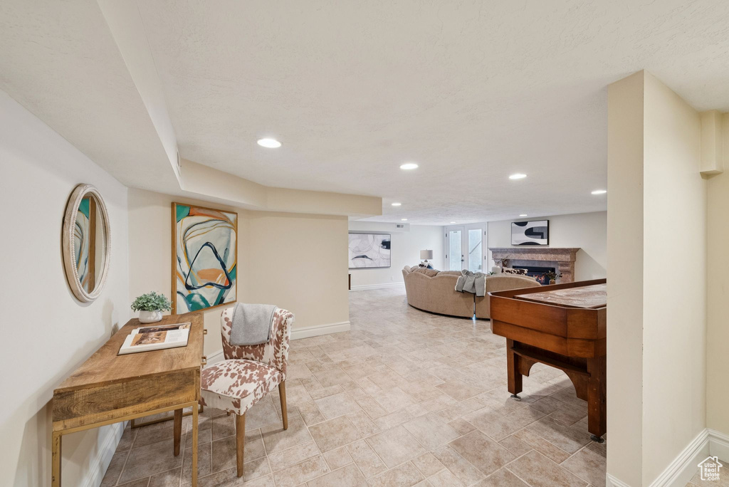 Interior space with a fireplace, baseboards, and recessed lighting