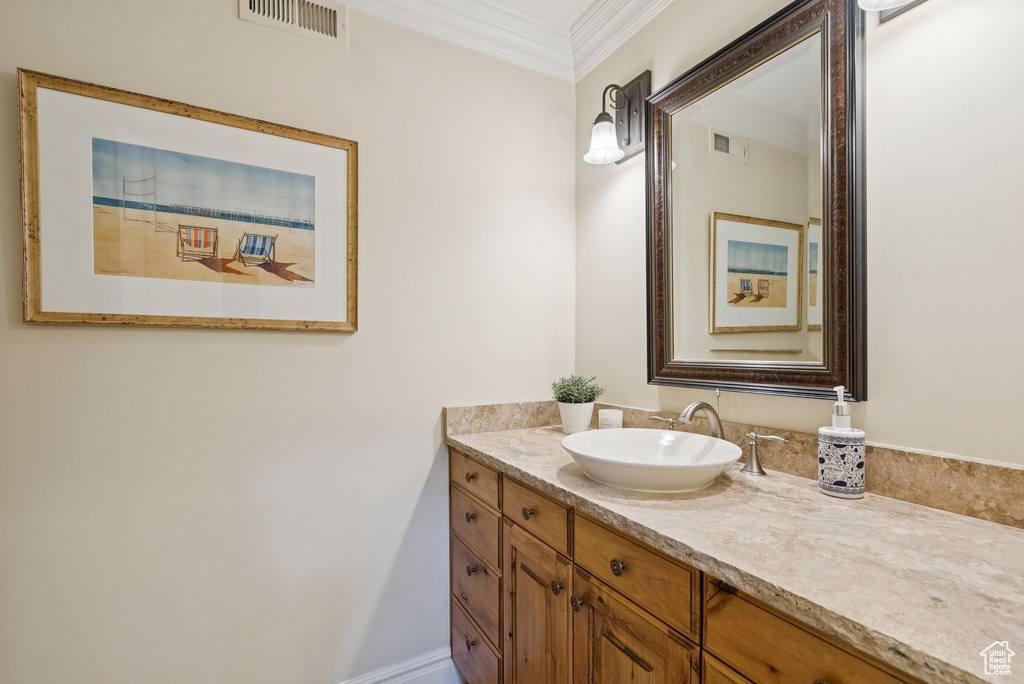 Bathroom with vanity and crown molding