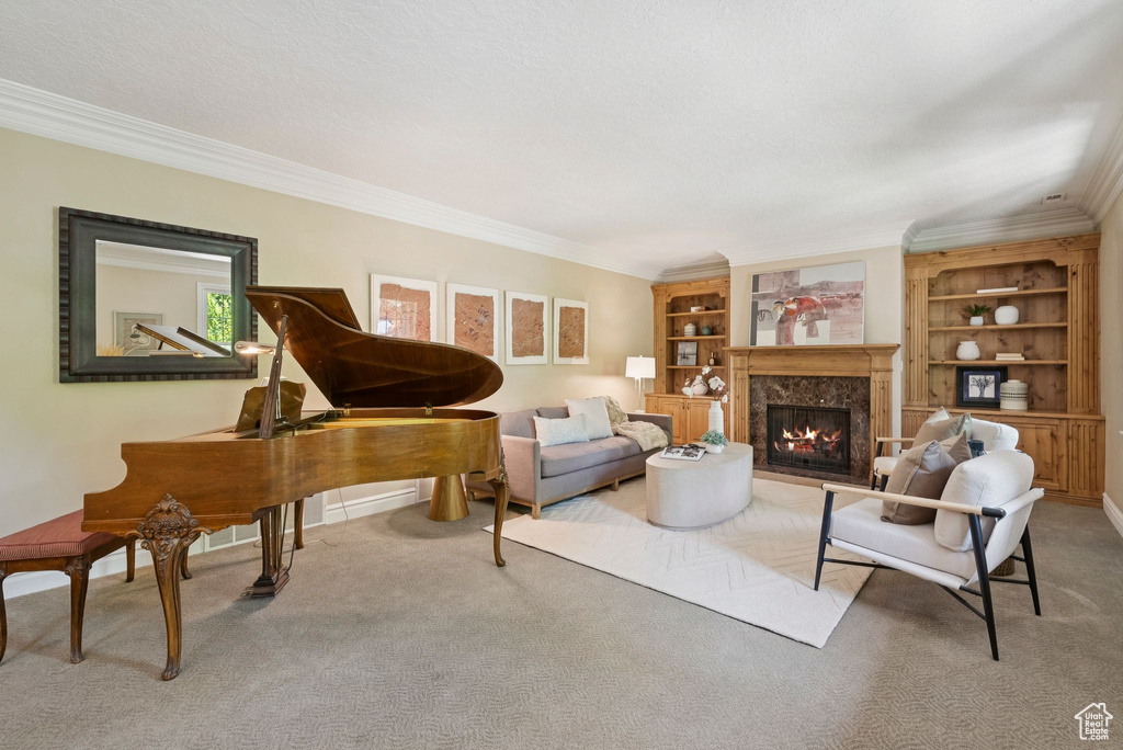 Living room with crown molding, carpet, and a high end fireplace