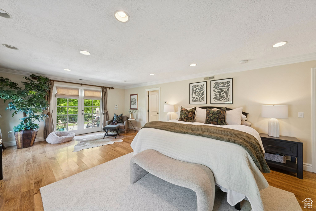 Bedroom with crown molding, access to exterior, recessed lighting, wood finished floors, and baseboards