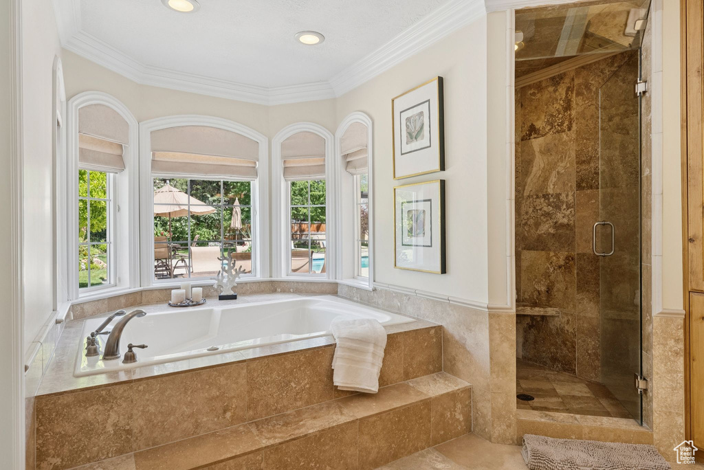 Full bathroom with a bath, a shower stall, ornamental molding, and recessed lighting