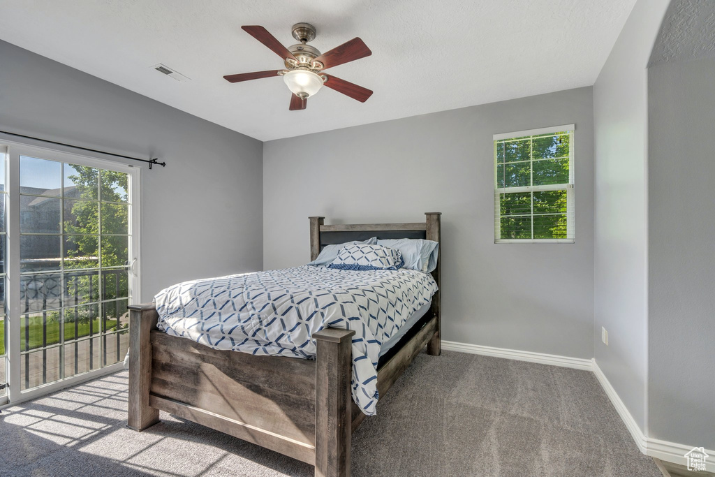 Bedroom featuring carpet floors, access to outside, baseboards, and ceiling fan